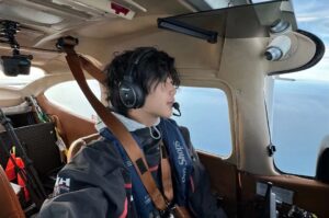 young man at the helm of a small plane