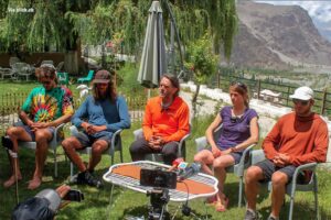 Marina Krauss and the international rescue team give a press conference while sitting at a garden in Skardu.