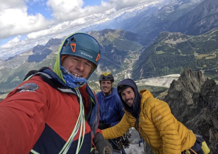 Climbers on a summit in the Mont Blanc massif.