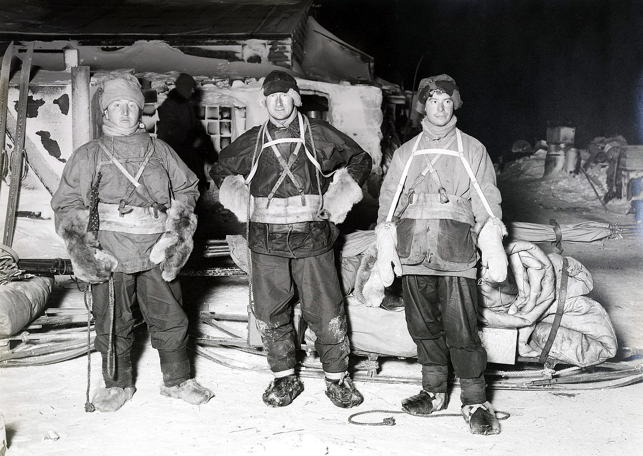 Three men in early 20th century sledging gear