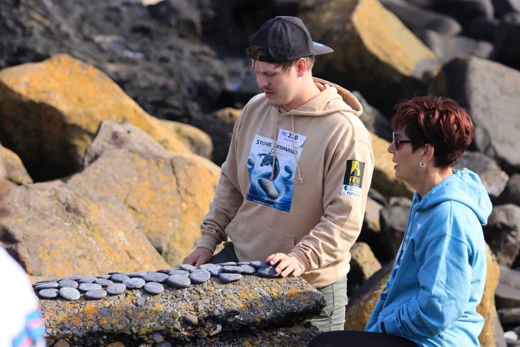 person looking at a bunch of small stones