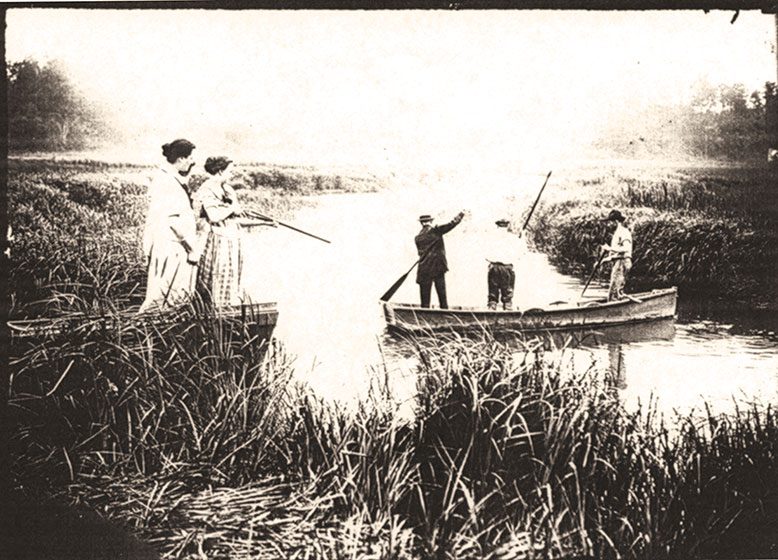 People aiming guns at the water