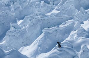 A climber in the middle of the mace of ice known as the Khumbu Icefall on Everest.