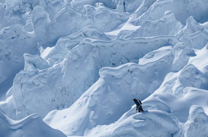A climber in the middle of the mace of ice known as the Khumbu Icefall on Everest.