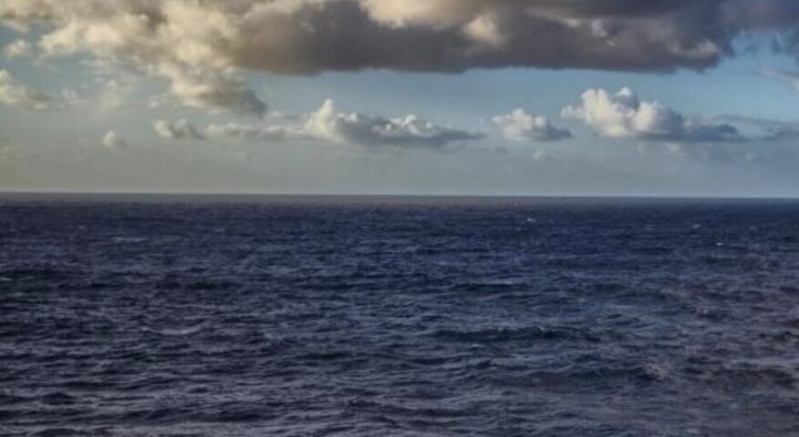 dark Pacific Ocean, with clouds above
