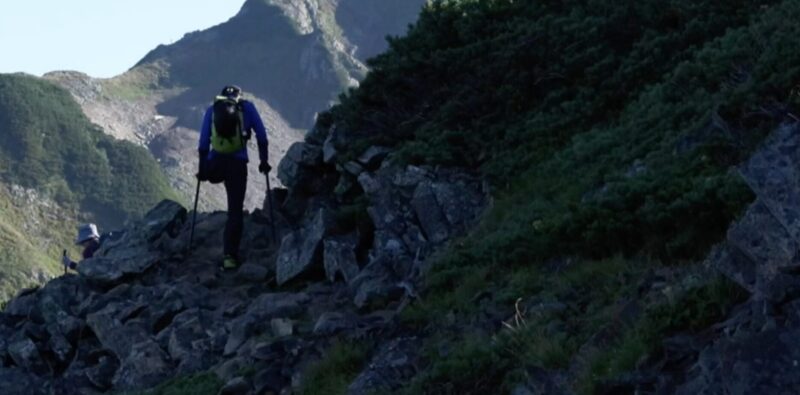 silhouette of one-legged climber on mountain