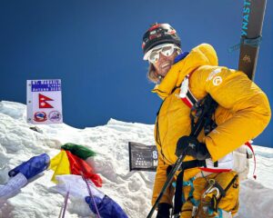Pôlish Bartek Ziemski smiles on the summit of Manaslu with his skis on the back, before skiing down the peak.