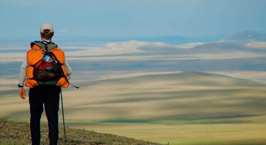 hiker overlooking arctic prairie