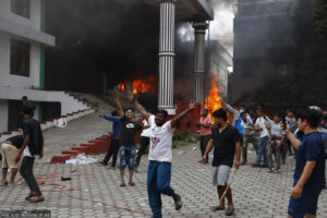 demonstrators set ablaze small fires in front of governmental buildings in Kathmandu.