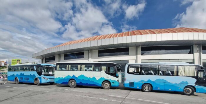 Blue buses in front of Kathmandu's Airport. 