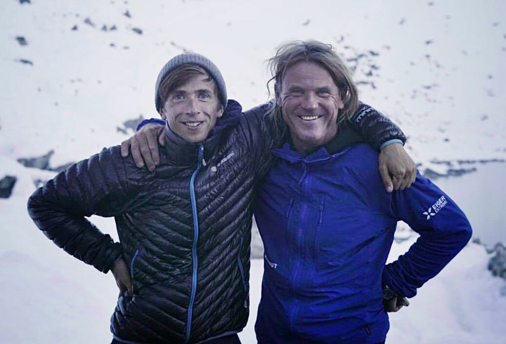 Groh and Holecek, shoulder to shoulder, with a background of a snowy mountain basin.