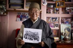 Kanchha Sherpa with the 1953 Everest team photo.