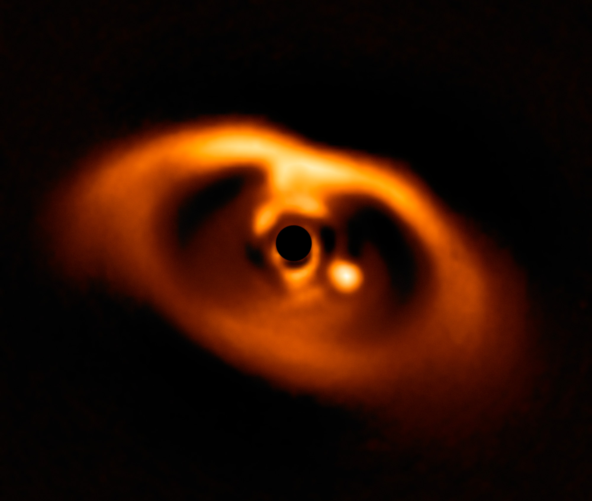 A red image of a baby star system.