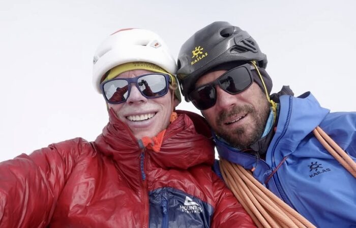 Close shot of the two climbers with sunglasses and helmets.