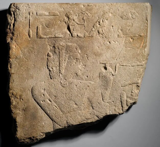 A limestone relief fragment showing heiroglyphics and a man