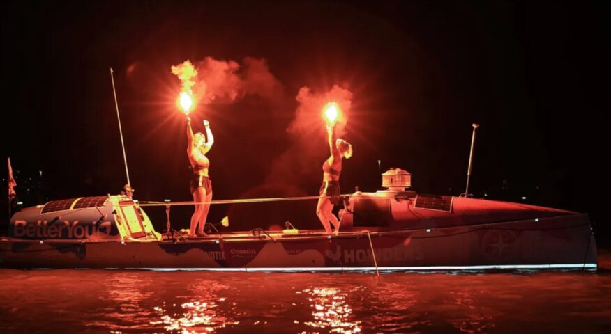 rowers light flares at night