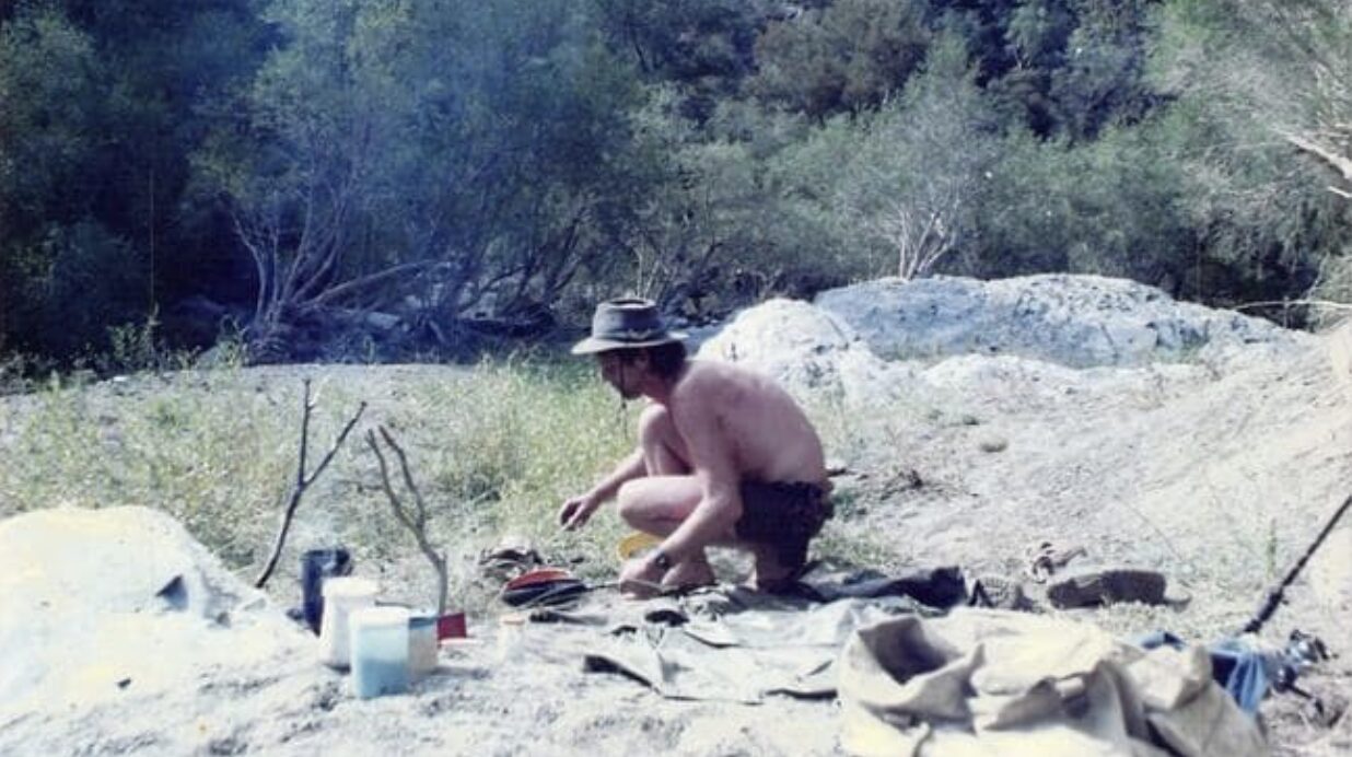 guy beside a campfire