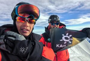 Chinese climbers take a selfie on a mountain top.