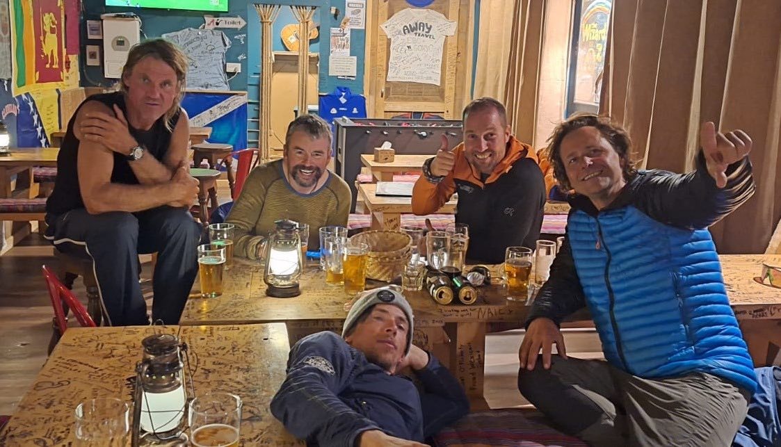 bunch of guys drinking beer in a pub
