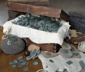 A wooden chest with pieces of eight in it.