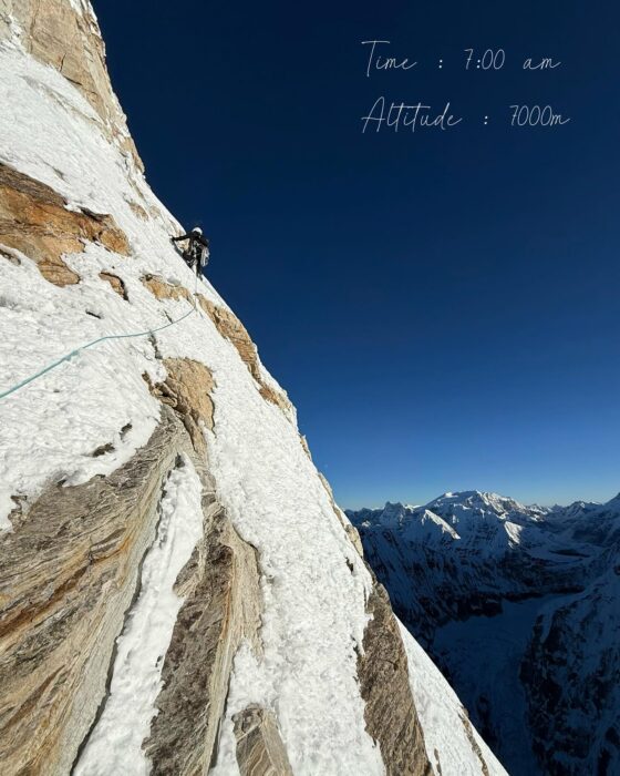 A climber on a mixed traverse vertical terrain.