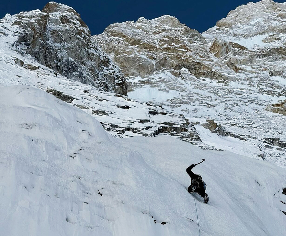 climber ice climbing with tools