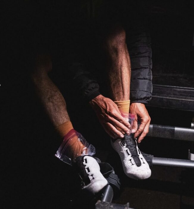 Kilian jornet's legs as he adjusts his cycling shoes. 