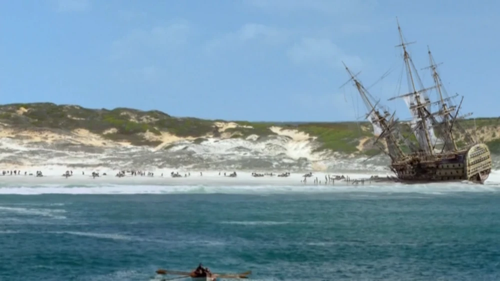 A photo of a ship wrecked on a beach.