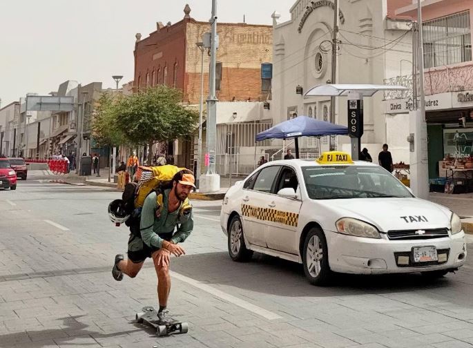 skateboarding down a main street in a small town