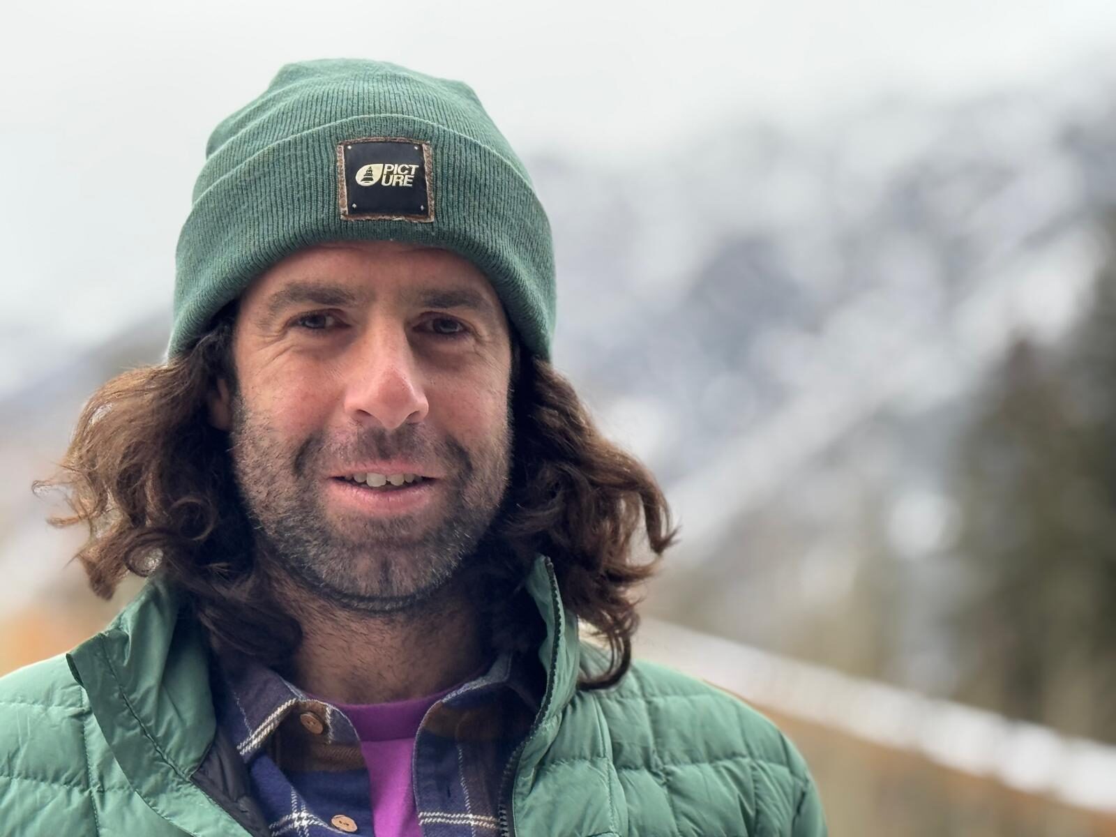 Close shot of Elias Millerioux in Banff wearing a green beanie.