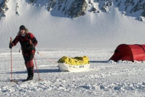 sled hauler pulling sled near tent