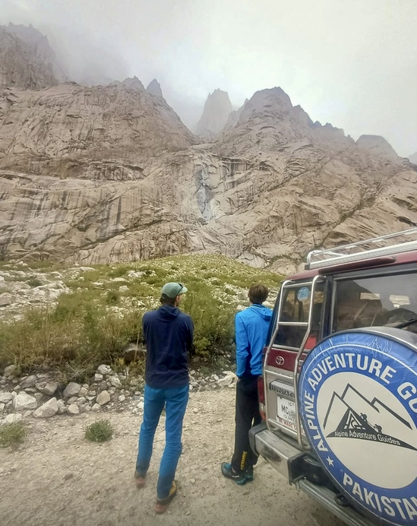 One of the climbers (right) contemplating the terrain from below with Ali Saltoro.