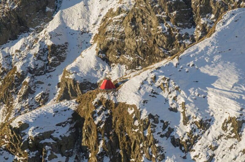 The bright red Frattini Bivouac sitting in the Italian Alps
