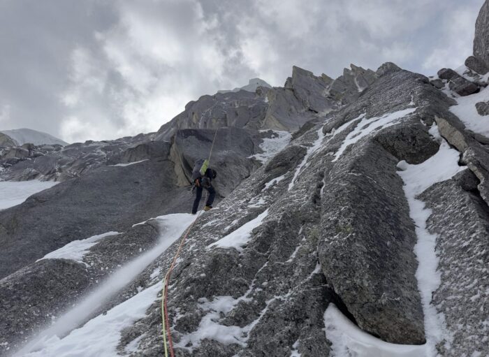 A climber on mixed terrain: frozen granite and ice.