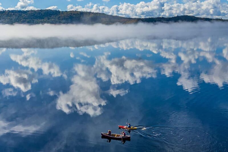two paddlers and mirrored lake