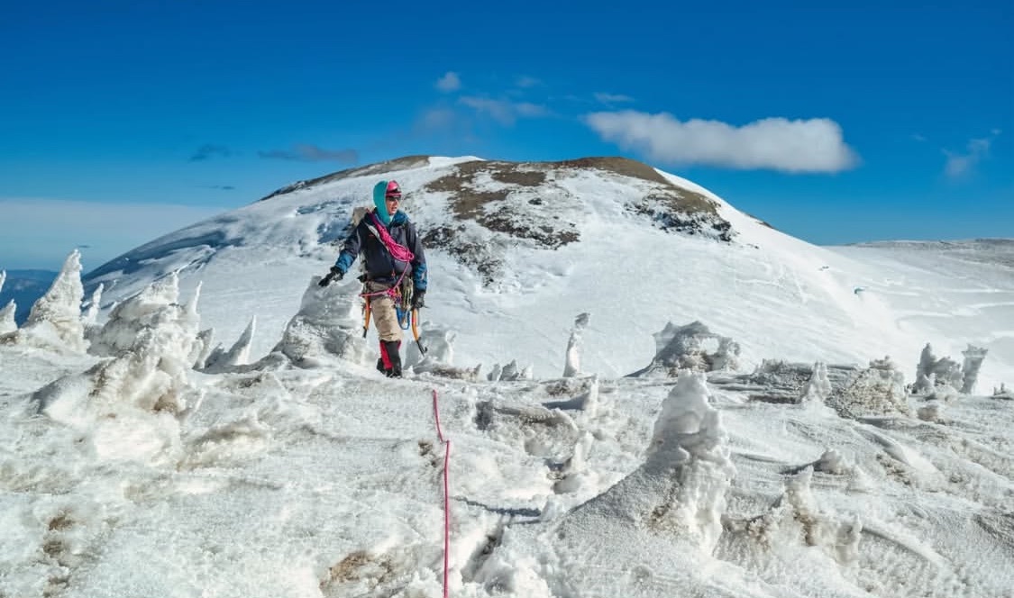 A man on a snowy peak