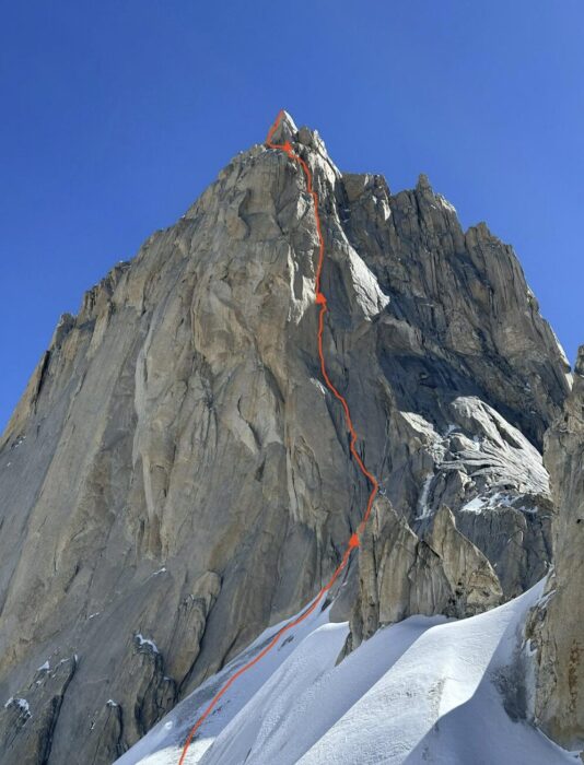 Route marked on the photo of a granite spire.