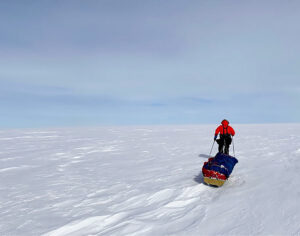 A skier manhauls across Antarctica.
