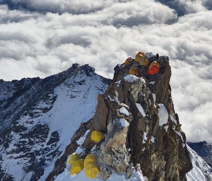 Tents on a rocky outcrop.
