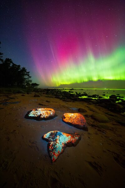 Aurora storm over a rocky beach