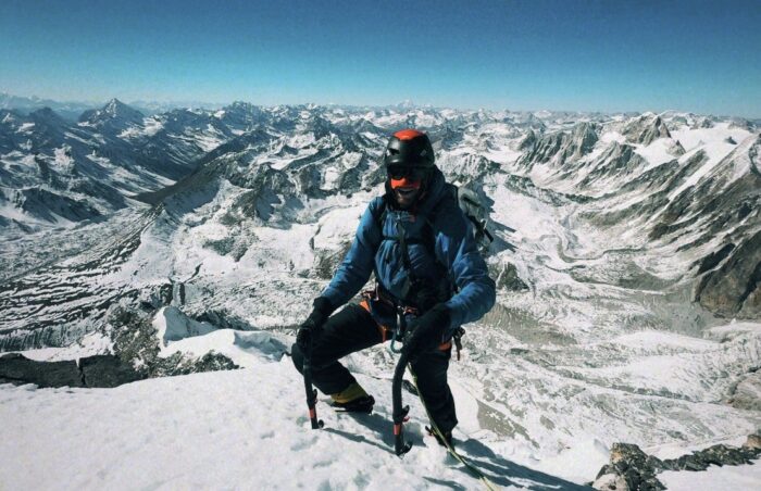 A climber on a summit in a clear day.