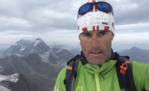 Selfie by Marco Confortola with Italian Alps mountains in background.