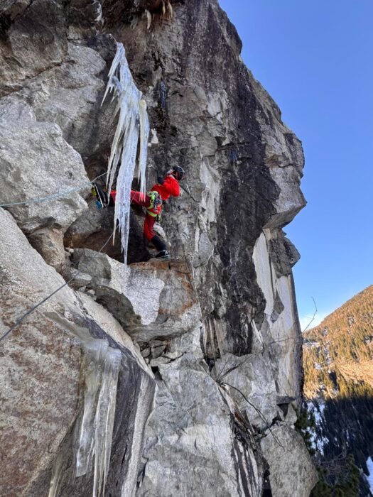 A climber on a mixed clmibing route on a granite face. 