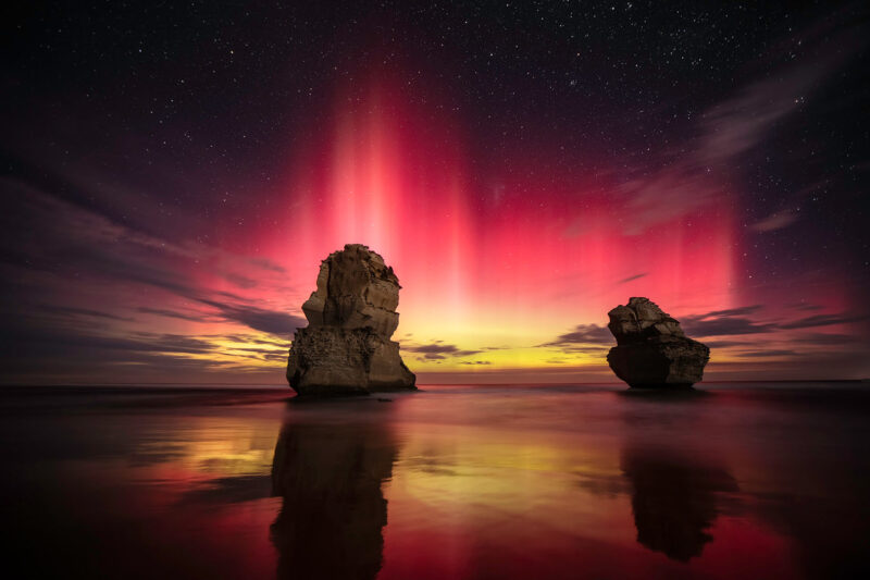 A red aurora over the Gog and Magog sea stacks