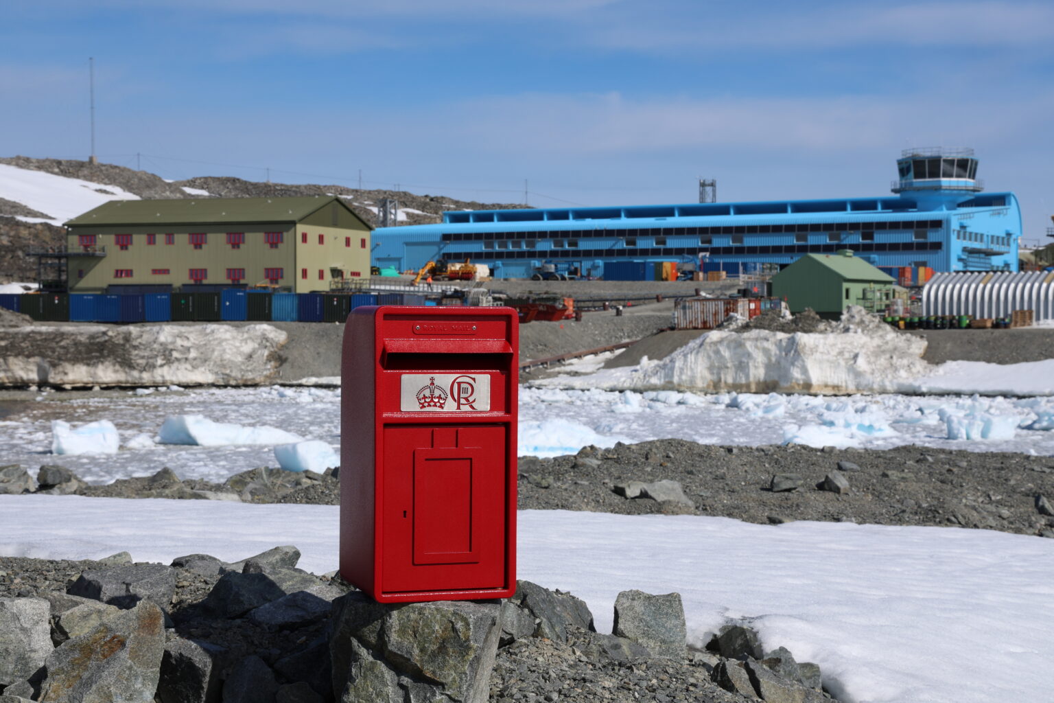 A small red postbox in an Antarctic research station
