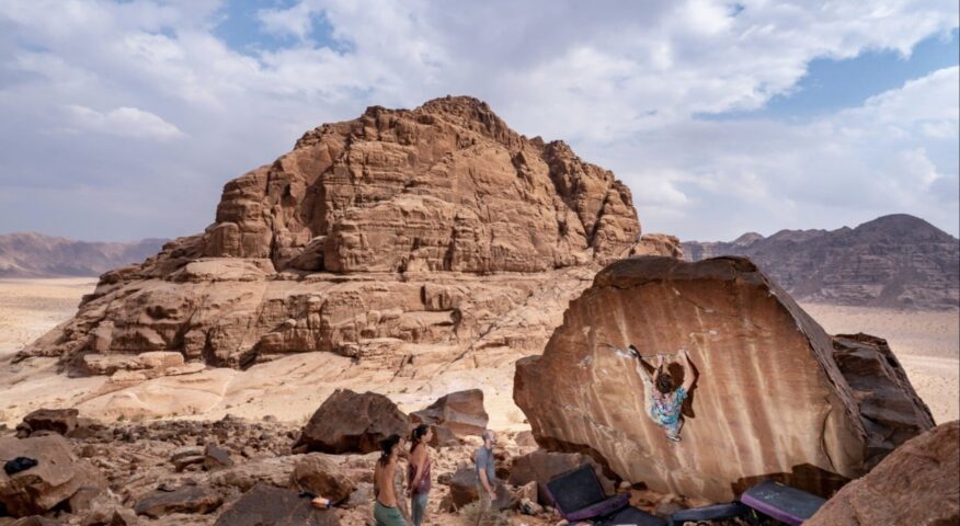 Lewis Perrin climbing on the Dajaj Aady boulder (7a), in the Shegeag sector of Wadi Rum.