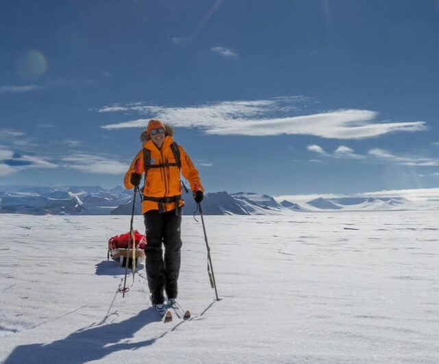A woman with skis in the Antarctic