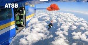 skydiver's parachute snagged on tail of plane