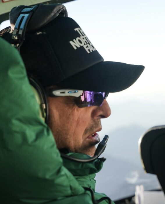 Close shot of Simone Moro in a helicopter. 