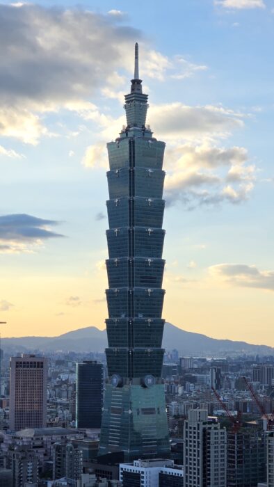 A skyscraper towering well above the rest of buildings in Taipei.